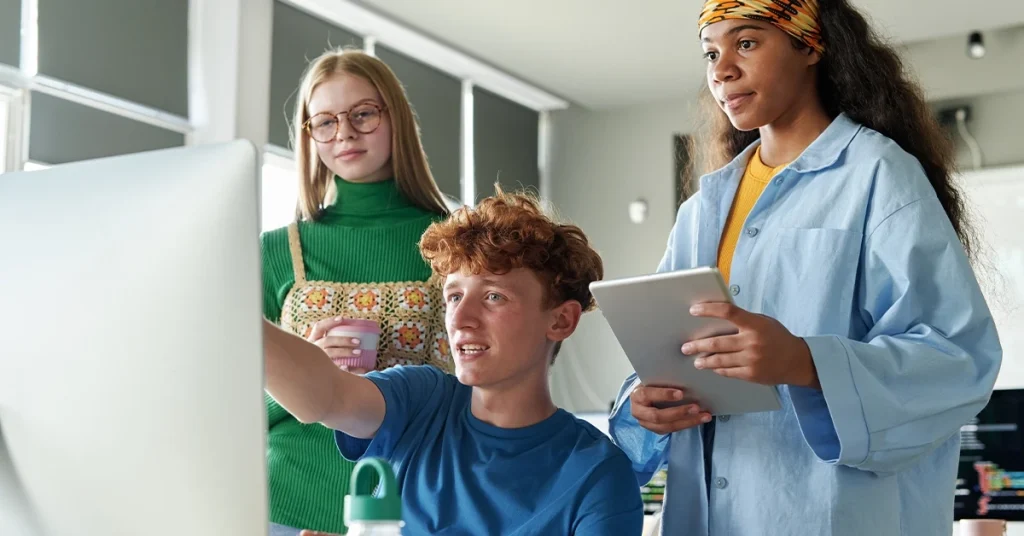 SAT Students discussing and comparing best prep books on desktop during a study session.