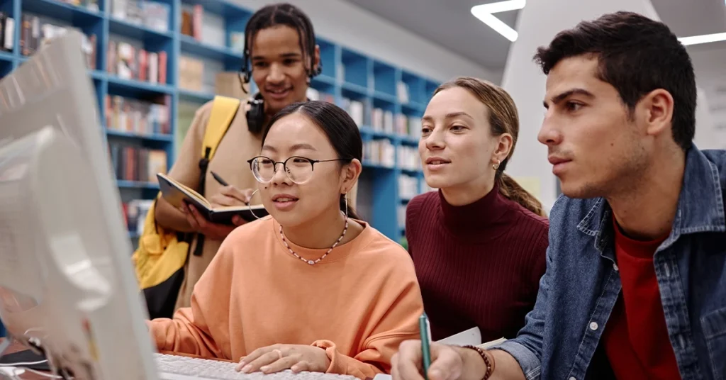 SAT Students comparing best prep course content on desktop during a collaborative study session.