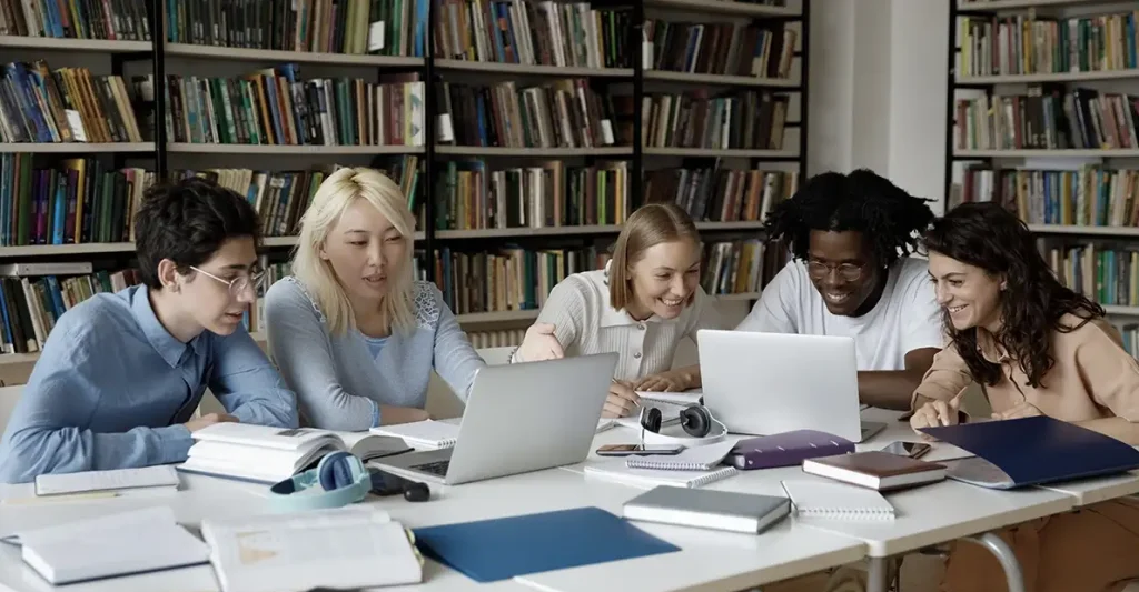 Students comparing the Best CMA® Review Courses 2026–27 on laptops in a library